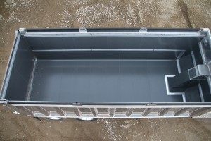 photo taken from above looking down into a dump truck with a black liner