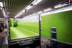 truck with green liner inside a large garage